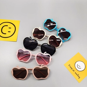 Five pairs of apple-shaped kids sunglasses in assorted colors with leaf detail