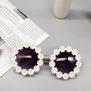 Detailed view of white daisy floral frames on round sunglasses for girls with grey lenses
