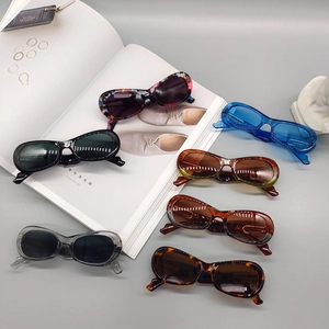 Fashionable oval frame sunglasses in multiple vintage colors on a stylish magazine background