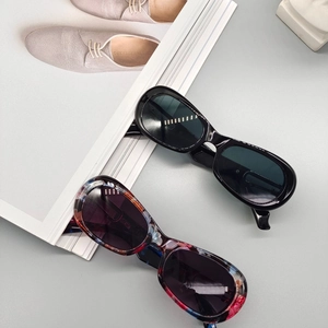 Modern oval fashion sunglasses with black and artistic marble texture frames for 2025
