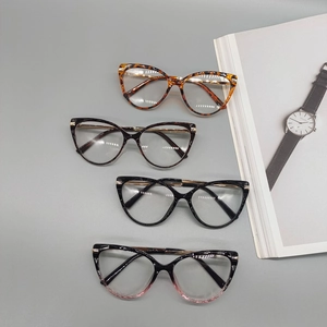 Cat-eye glasses in tortoiseshell, amber, and black frames with premium metal accents
