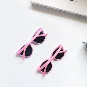 Detailed top view of two pairs of pink and purple cat-eye polarized kids sunglasses