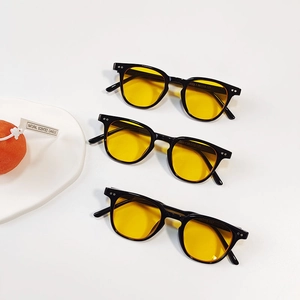 Three pairs of retro round-frame kids sunglasses with black frames and yellow lenses