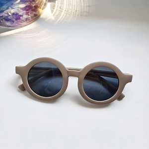 Detail of round matte khaki kids sunglasses featuring UV protection and dark lenses