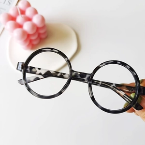 Detail of round kids glasses frames with stylish black and white marble pattern texture