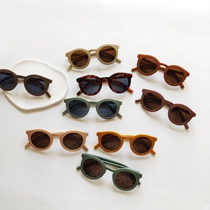 Kids round frame sunglasses collection in nine assorted creamy colors on white background