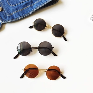 Three pairs of vintage round kids sunglasses in gold and silver frames on white background