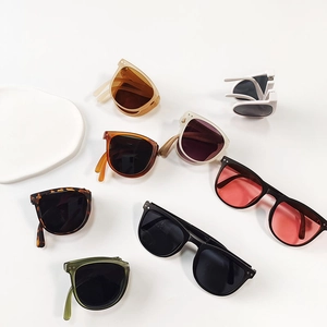Detailed view of colorful foldable sunglasses for kids showing multiple frame color options