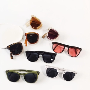 Close-up of portable folding sunglasses for kids in various colors with matte frames