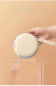 Detail view of 10cm beige EVA round storage case with zipper and lanyard handle