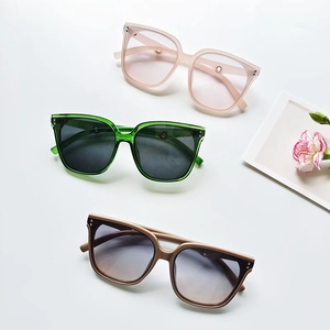Retro oversized sunglasses in pink, green, and tea colors with metal rivet accents
