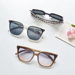 Chic oversized sunglasses in black, tea-gradient, and checkered frames on white background