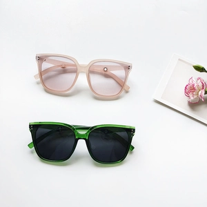 Fashionable oversized square sunglasses with translucent frames and metal rivet accents