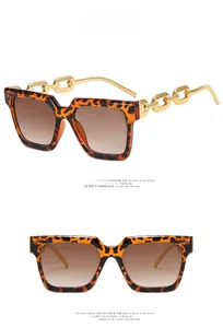Detail view of tortoiseshell square sunglasses with gold metal chain link temples