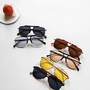 Detail of assorted kids aviator sunglasses with colorful lenses and stylish retro frames