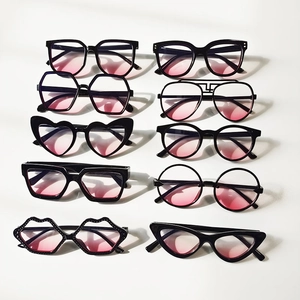 Flat lay of 10 assorted black frame kids sunglasses with pink gradient lenses in a grid