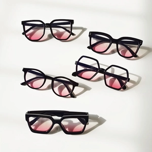 Flat lay of five kids sunglasses featuring black frames and pink gradient lenses