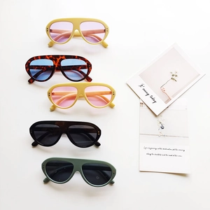 Five pairs of vintage oval kids sunglasses in assorted colors with metal accents