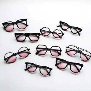 Collection of kids sunglasses with black frames and pink gradient lenses in various styles