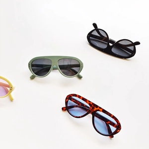 Top view of retro oval children's sunglasses in black, olive, leopard, and yellow tones