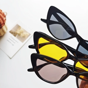 Close-up of children's triangle cat-eye sunglasses with UV400 protection and thick frames