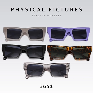 Close-up of five colorful square frame sunglasses in a neat commercial product display
