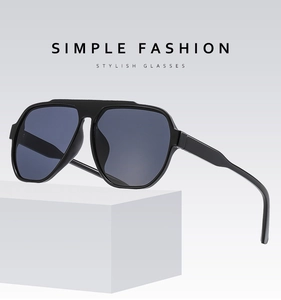 Detail of pilot-style oversized sunglasses featuring double-bridge matte black frames