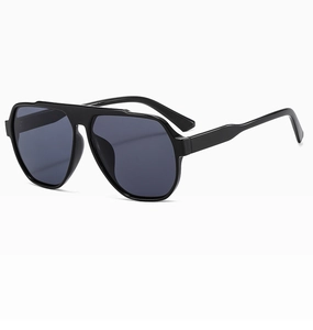 Detail of pilot-style oversized sunglasses with black frame and dark grey lenses