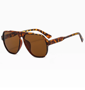 Close-up of tortoise shell pattern on classic aviator sunglasses with brown lenses