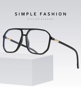 Detail of retro pilot double bridge glasses frame with gold metal hinges on white cube