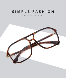 Macro detail of tortoise shell frame glasses with dual bridge and metal hinges