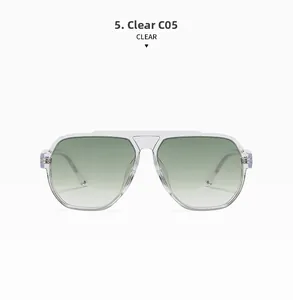 Detail of transparent aviator sunglasses with green gradient lenses and purple metal hinges