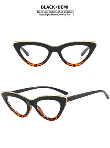 Detail of cat-eye sunglasses with black and demi frame and gold metal accents