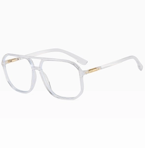 Detail of transparent double-bridge pilot frame glasses with gold metal hinge accents