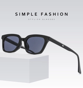 Classic black square frame sunglasses with sleek silver hinge detail on a minimalist stand
