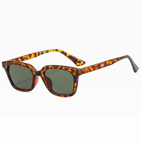 Detail shot of vintage tortoiseshell sunglasses with dark green lenses on white background