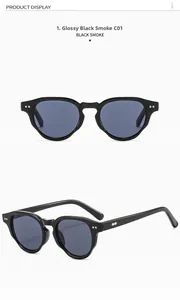 Detail view of round black frame sunglasses with shiny grey lenses and silver rivets