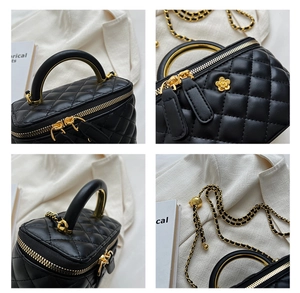 Detail of quilted leather bag featuring gold hardware and pearl flower ornament
