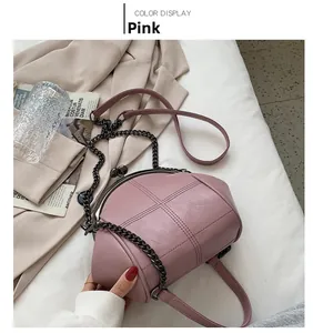 Detail of pink vintage shell bag with criss-cross stitching and antique silver metal frame