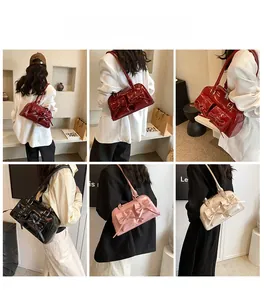 Model view of stylish patent leather shoulder bags with bow details in multiple colors