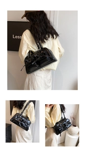 Detailed views of a black patent leather shoulder bag with decorative bows and long tassels