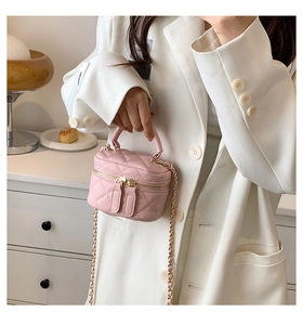 Detailed view of pink quilted PU leather vanity bag with chain strap and gold hardware