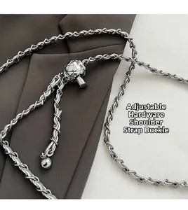 Close-up of silver metal chain strap with adjustable quilted ball buckle for handbags