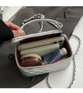 Detail of silver quilted crossbody bag showing spacious interior with daily essentials