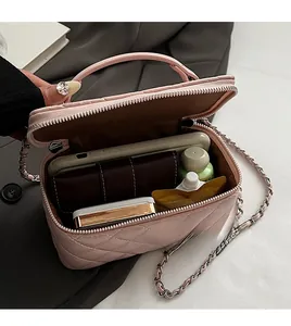 Pink quilted bag showing spacious interior for phone, wallet and cosmetics with chain strap