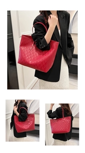 Detail view of a large red tote bag with quilted rhombus texture and shoulder straps