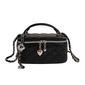 Quilted black leather crossbody vanity bag with silver chain strap and heart charm