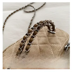 Detail of khaki quilted suede handbag with chunky silver chain and leather handle