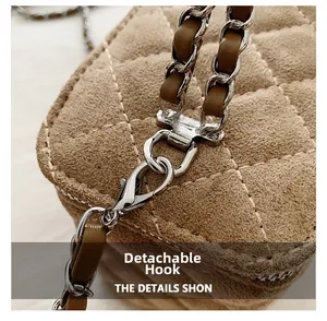 Detail of detachable gold hook and quilted suede texture on the brown chain crossbody bag