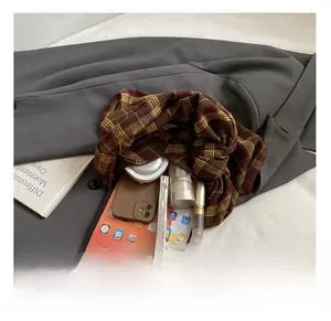 Detail showing the large interior capacity of the checkered tote bag with daily essentials